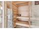 Cozy home sauna featuring wood paneling, tiled floors, and modern sauna equipment at 1194 N Peninsula, New Smyrna Beach, FL 32169