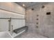 Gorgeous bathroom shower with stylish tiling, a built-in seat, and multiple shower heads at 1194 N Peninsula, New Smyrna Beach, FL 32169
