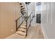 Modern staircase with wood treads, glass railings, and sleek black hardware for a contemporary design at 1194 N Peninsula, New Smyrna Beach, FL 32169