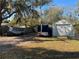 View of the property's backyard with a boat, storage trailer, and shed at 1208 Pat Ave, New Smyrna Beach, FL 32168