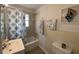 Bathroom with shower-tub combo, single sink vanity, and decorative seashell art at 1208 Pat Ave, New Smyrna Beach, FL 32168
