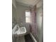 Cozy bathroom featuring a sink, mirror, and a shower with a decorative curtain at 1208 Pat Ave, New Smyrna Beach, FL 32168