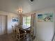 Cozy dining room features a wooden table, four chairs, and a picturesque window view at 1208 Pat Ave, New Smyrna Beach, FL 32168