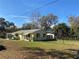 Charming yellow home featuring a well-kept lawn and secure fencing at 1208 Pat Ave, New Smyrna Beach, FL 32168