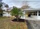 Carport area surrounded by lush landscaping, complemented by a shed in the backyard at 1208 Pat Ave, New Smyrna Beach, FL 32168