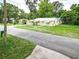 Charming yellow home with a well-maintained lawn and mature landscaping at 1208 Pat Ave, New Smyrna Beach, FL 32168