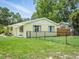 Exterior view of the home with a fenced yard and well-manicured lawn at 1208 Pat Ave, New Smyrna Beach, FL 32168