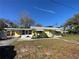 Charming yellow home featuring a carport, well-maintained landscaping, and inviting curb appeal at 1208 Pat Ave, New Smyrna Beach, FL 32168