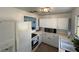 Bright kitchen with white cabinets, an oven and range and a window over the sink at 1208 Pat Ave, New Smyrna Beach, FL 32168