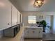 Bright kitchen with white cabinets, laminate countertops, and natural light at 1208 Pat Ave, New Smyrna Beach, FL 32168