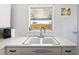 Functional kitchen sink area with ample counter space and natural light from the window at 1208 Pat Ave, New Smyrna Beach, FL 32168