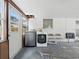 Living room featuring white walls, a washing machine and chairs at 1208 Pat Ave, New Smyrna Beach, FL 32168