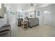 Open concept living room featuring modern sofas, ceiling fans, and natural light at 1208 Pat Ave, New Smyrna Beach, FL 32168