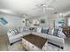 Inviting living room with coastal decor, features a large sectional sofa and comfortable seating at 1208 Pat Ave, New Smyrna Beach, FL 32168