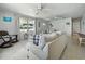 Living room with stylish furniture, ceiling fans, and access to other rooms at 1208 Pat Ave, New Smyrna Beach, FL 32168