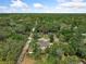 Discover an aerial perspective showcasing a home nestled among mature trees at 1290 9Th St, Orange City, FL 32763