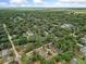 Expansive aerial view of a neighborhood lush with mature trees in a serene, wooded setting at 1290 9Th St, Orange City, FL 32763
