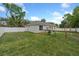 Expansive backyard with a white fence and mature trees offering privacy and serenity at 1290 9Th St, Orange City, FL 32763