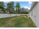 Spacious backyard with a white fence, green grass, and potential for gardening or play at 1290 9Th St, Orange City, FL 32763