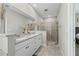 This bathroom features dual sinks, white cabinets, granite countertops and tiled glass shower at 1290 9Th St, Orange City, FL 32763