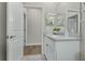 Well-lit bathroom featuring a white vanity with granite countertops and modern fixtures at 1290 9Th St, Orange City, FL 32763
