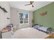 The room features a large window, green accent wall and wood style ceiling fan at 1290 9Th St, Orange City, FL 32763