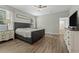 This primary bedroom features wood floors, neutral paint, ceiling fan and light wood furniture at 1290 9Th St, Orange City, FL 32763