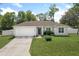 Charming single-story home with a well-manicured lawn, fresh landscaping and a white two-car garage at 1290 9Th St, Orange City, FL 32763