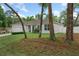 Inviting single-story home with lush green lawn, white privacy fence, and a charming landscaped garden at 1290 9Th St, Orange City, FL 32763
