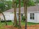 Inviting single-story home with lush green lawn, white privacy fence, and a charming landscaped garden at 1290 9Th St, Orange City, FL 32763