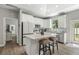 Well-lit kitchen with white cabinetry, granite countertops, mosaic backsplash and stainless-steel appliances at 1290 9Th St, Orange City, FL 32763