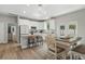 Bright kitchen with white cabinetry, granite countertops, kitchen island and dining nook at 1290 9Th St, Orange City, FL 32763