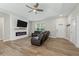 Spacious living room with hardwood flooring, tray ceiling, fireplace, and natural light through the windows at 1290 9Th St, Orange City, FL 32763