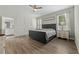 Comfortable main bedroom with wood floors, a stylish bed, and en-suite bathroom at 1290 9Th St, Orange City, FL 32763