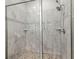 This tiled shower features marble styled tiling, and pebble styled floor at 1290 9Th St, Orange City, FL 32763