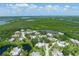 Aerial view of a waterfront community with lush trees, a pond, and stunning water views at 135 Cedar Dunes Dr, New Smyrna Beach, FL 32169