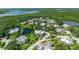 An aerial view of a waterfront community surrounded by lush greenery and a tranquil pond at 135 Cedar Dunes Dr, New Smyrna Beach, FL 32169