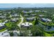 Aerial view of a coastal community with lush greenery, nearby beach and city skyline at 135 Cedar Dunes Dr, New Smyrna Beach, FL 32169