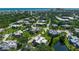 Aerial view of a coastal community with lush greenery, nearby beach and city skyline at 135 Cedar Dunes Dr, New Smyrna Beach, FL 32169