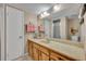 Bathroom featuring an extended vanity with sink and framed mirror plus a shower and bath at 135 Cedar Dunes Dr, New Smyrna Beach, FL 32169