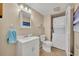 Bathroom equipped with a toilet and a stacked washer/dryer, offering convenience and functionality at 135 Cedar Dunes Dr, New Smyrna Beach, FL 32169