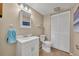 Neutral bathroom featuring a single sink vanity, a toilet, and a mirrored medicine cabinet at 135 Cedar Dunes Dr, New Smyrna Beach, FL 32169
