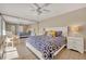Spacious bedroom featuring ample natural light, a ceiling fan, and a large mirrored closet at 135 Cedar Dunes Dr, New Smyrna Beach, FL 32169