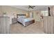 Cozy bedroom featuring a comfortable bed with a ceiling fan and closet with mirrored doors at 135 Cedar Dunes Dr, New Smyrna Beach, FL 32169