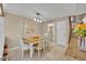 Well-lit dining area with tile flooring, neutral walls, wooden table and chairs, and a view of stairs at 135 Cedar Dunes Dr, New Smyrna Beach, FL 32169