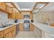 Charming kitchen showcasing wood cabinets, stainless steel appliances, and an inviting breakfast bar at 135 Cedar Dunes Dr, New Smyrna Beach, FL 32169