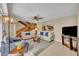 The living room boasts a staircase, comfortable couches, a ceiling fan, and tasteful decorations at 135 Cedar Dunes Dr, New Smyrna Beach, FL 32169