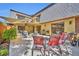 Inviting outdoor patio with seating, grill, fire pit, and partial shade cover, perfect for relaxing and entertaining at 135 Cedar Dunes Dr, New Smyrna Beach, FL 32169