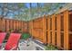 Private patio area with a wooden fence and lush greenery, perfect for relaxation at 135 Cedar Dunes Dr, New Smyrna Beach, FL 32169