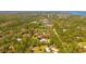 Expansive aerial view of a property surrounded by lush greenery, offering privacy and a serene setting at 1370 Jane Lacey Ln, New Smyrna Beach, FL 32168